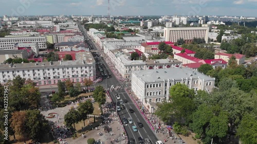 Peaceful belarusian activists people walk along a city street in a protest march. Presidential elections in Belarus 2020. Top view: Gomel, Belarus - 08.16.2020 photo