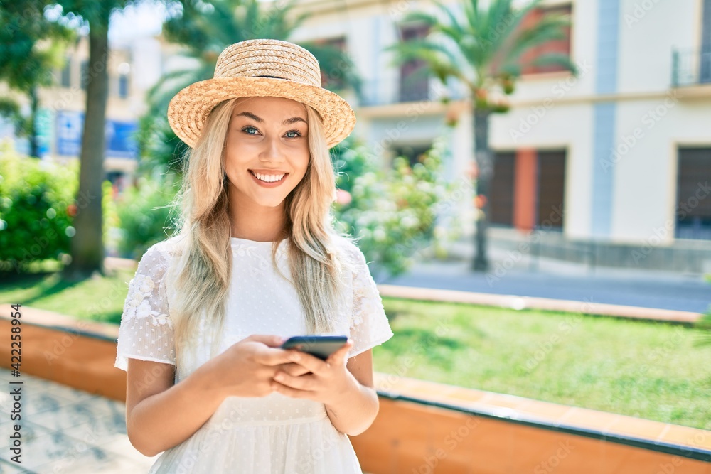 Young caucasian tourist girl smiling happy using smartphone at street of city.