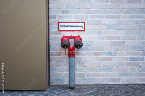 Fire water supply with two outlets is located at a building.