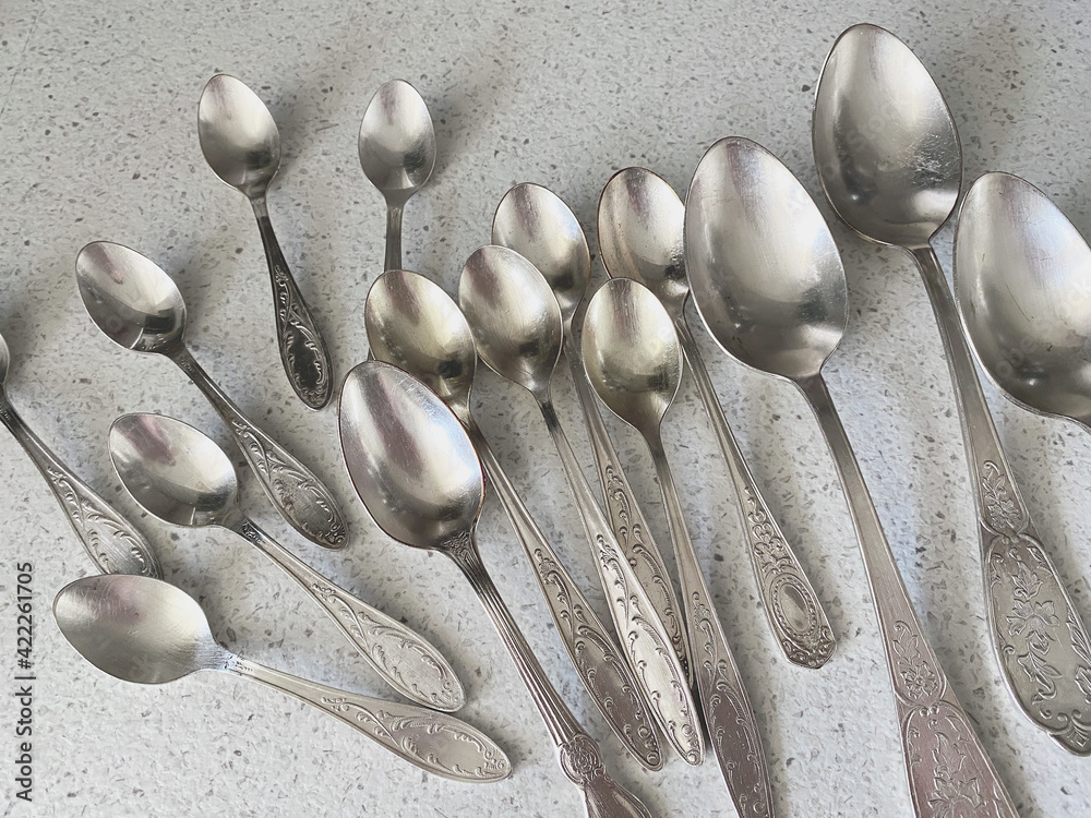 Vintage spoons collection isolated on white granite background. Retro