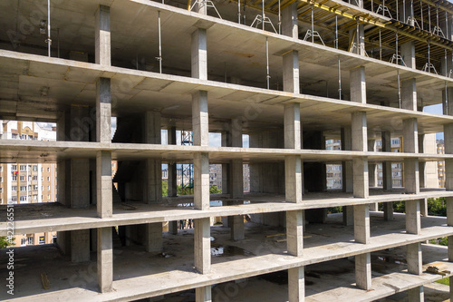 Aerial view of high frame of monolithic concrete building under construction. Real estate development. © bilanol