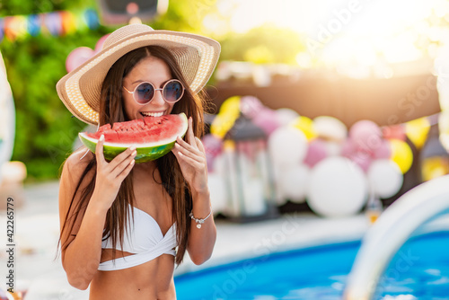 Slika na platnu Young girl eating watermelon