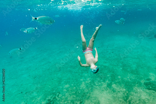 Little kid diving on the Mediterranean sea