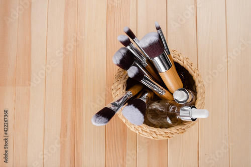 Set of bamboo make-up brushes, shot on abstract background. Grouped together . Top horizontal view copyspace sckin care and make up concept photo