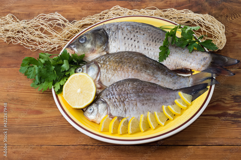 Carp and crucians prepared for cooking on dish Carp and crucians prepared for cooking on dish