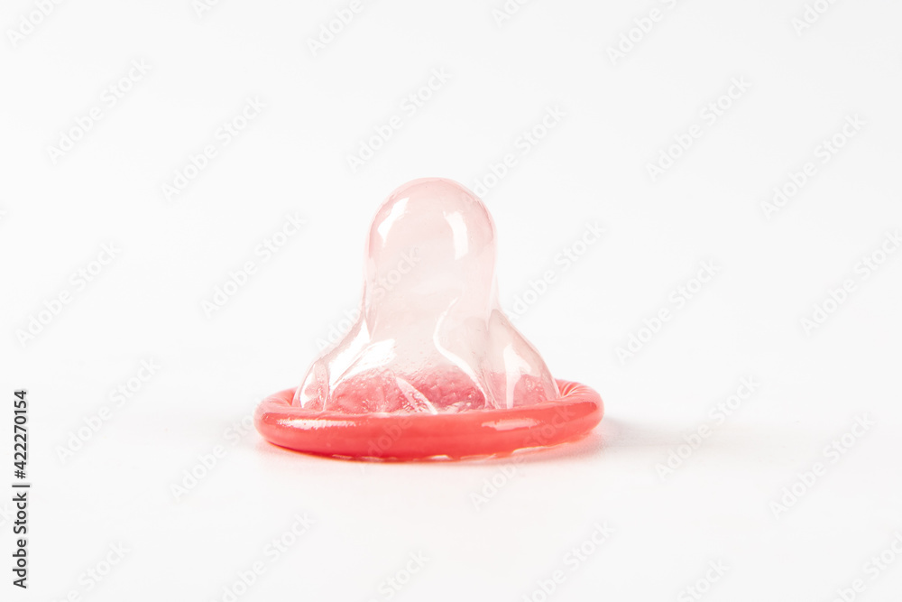 Pink condom isolated on white background.Having safe sex Pink condom isolated on white background.Having safe sex