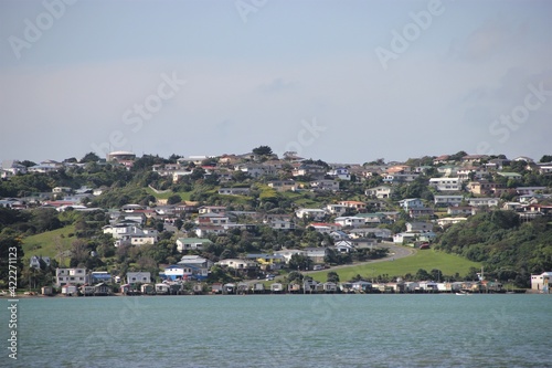 The Eastern side of the Porirua suburb of Titahi Bay, a traditional New Zealand suburb made up of a wild and colorful variety of detached homes along the emerald waters of Porirua Harbour