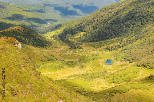 Scenic view of Small Apshynets glacial lake and Svydovets mountain range at sunny summer day, Ukrainain Carpathians photo