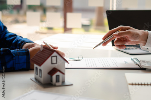 Buying a Home or Insurance, an insurance agent explains the lease agreement to a client before making a contract. Mortgage loan approval home loan and insurance concept.