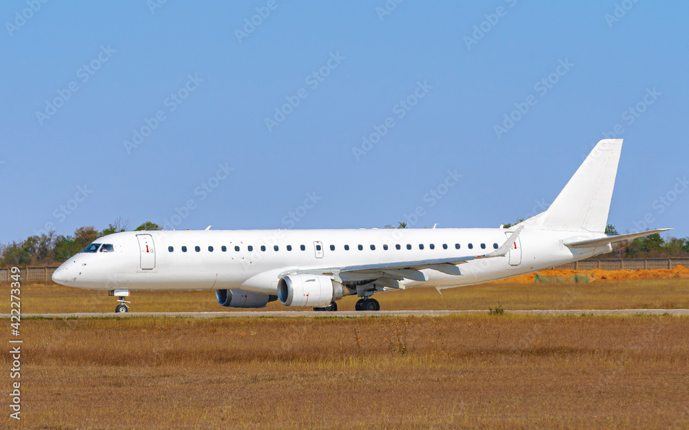 Big passenger airplane drives along the runway in airport Big passenger airplane drives along the runway in airport