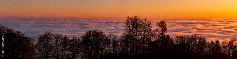 Fototapeta premium High resolution stitched panorama of a beautiful sunset above the clouds at the famous Grandsberg, Bavarian forest, Bavaria, Germany