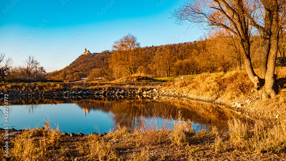 Fototapeta premium Beautiful autumn or indian summer view with reflections at the famous Bogenberg, Danube, Bavaria, Germany