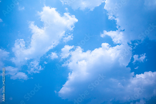 Blue sky white clouds floating in the sky and The light from the sun shines through the beautiful clouds.for background concept.