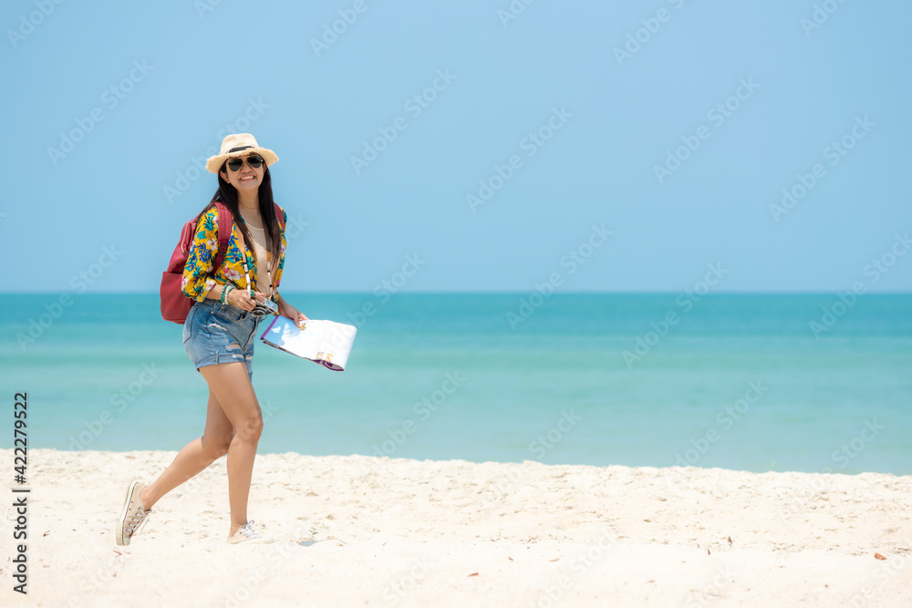 Happy traveler and tourism women travel summer on the beach. Asia smiling people holding map and camera planning travel trip and relax outdoor for destination and leisure. Happy traveler and tourism women travel summer on the beach. Asia smiling people holding map and camera planning travel trip and relax outdoor for destination and leisure.