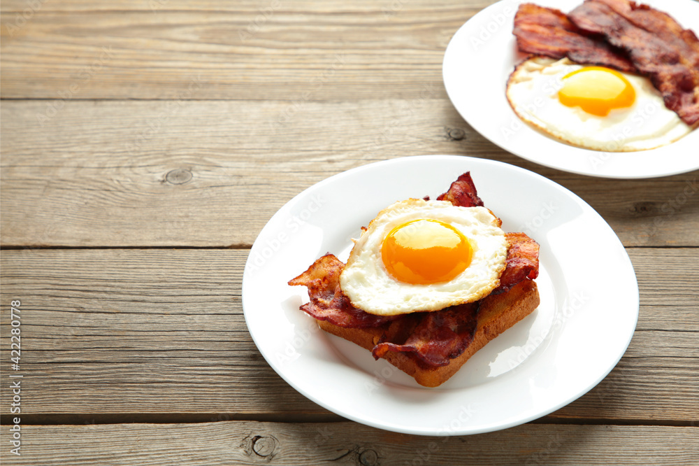 Eggs and bacon for breakfast on grey background. English breakfast with copy space. Eggs and bacon for breakfast on grey background. English breakfast with copy space.