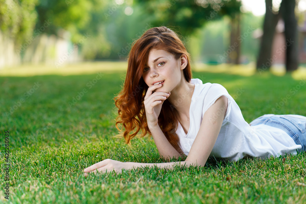 woman lies in the park on the lawn in the fresh air woman lies in the park on the lawn in the fresh air
