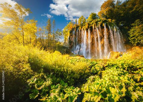 Breathtaking view of the grand waterfall on a sunny day. Location place of Plitvice Lakes National Park, Croatia.