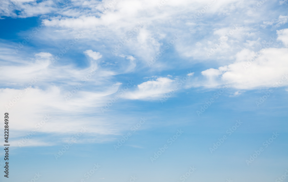 Blue sky background with white fluffy clouds in sunny day.