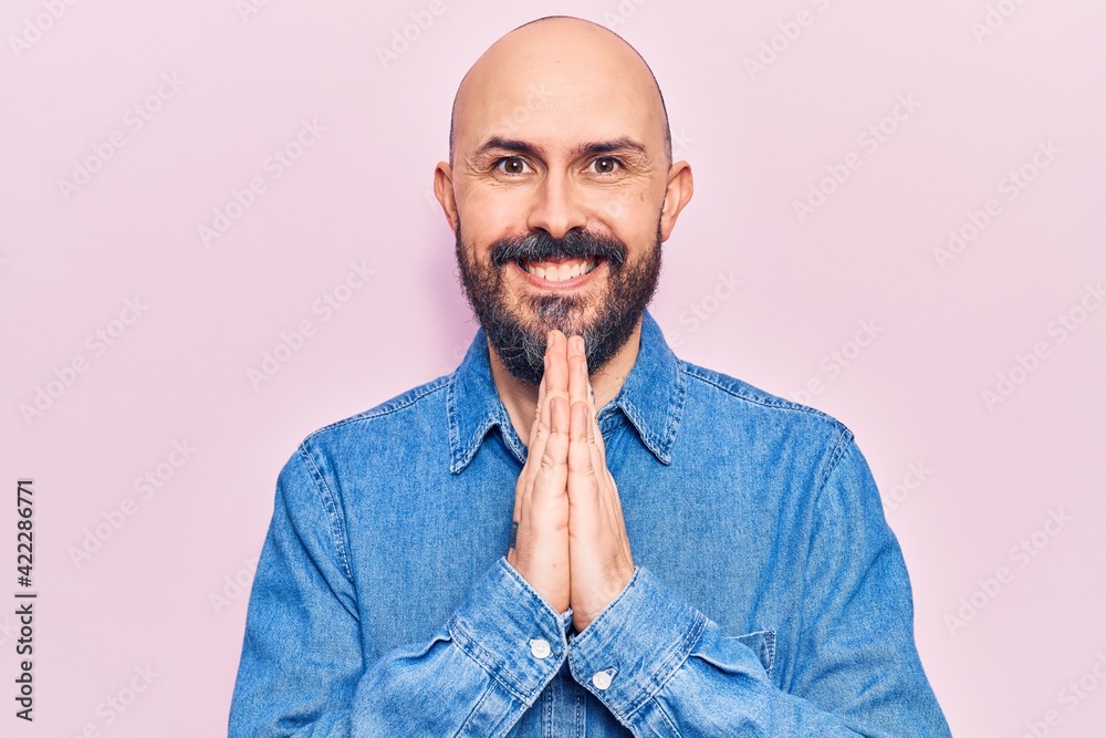 Young handsome man wearing casual clothes praying with hands together asking for forgiveness smiling confident. Young handsome man wearing casual clothes praying with hands together asking for forgiveness smiling confident.