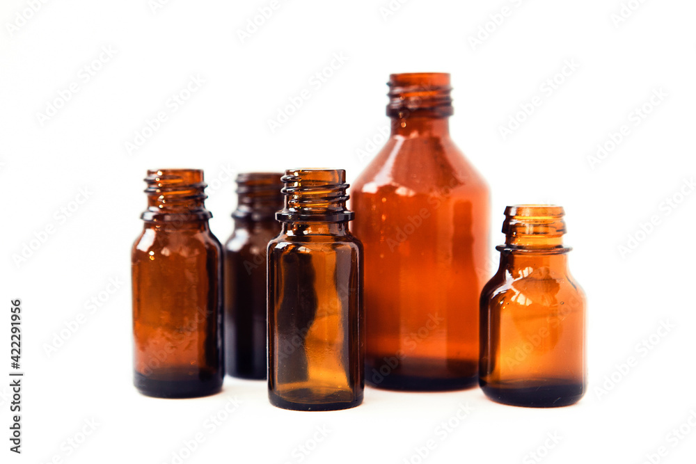 Dark brown phials on white background. Small empty bottles Dark brown phials on white background. Small empty bottles