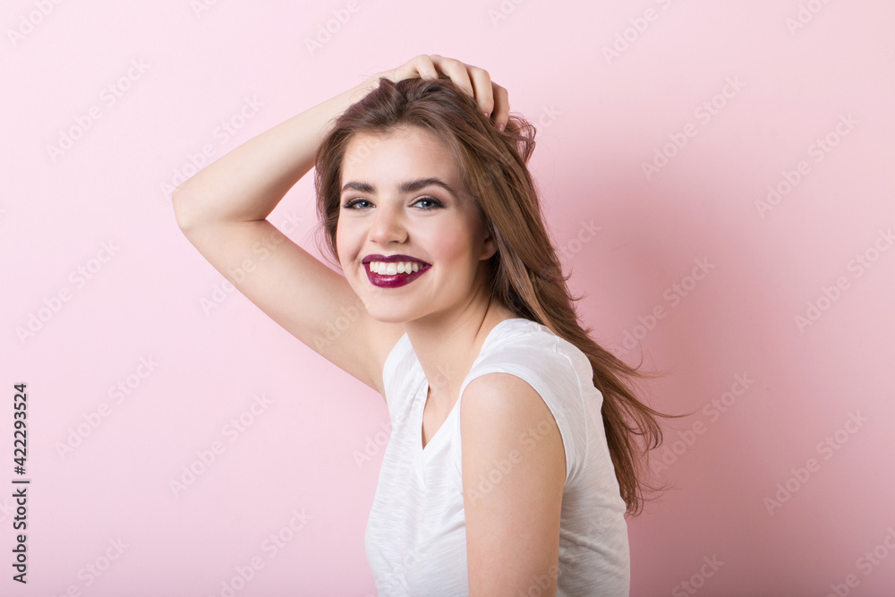 Portrait of a natural beautiful smiling woman on a pink background Portrait of a natural beautiful smiling woman on a pink background