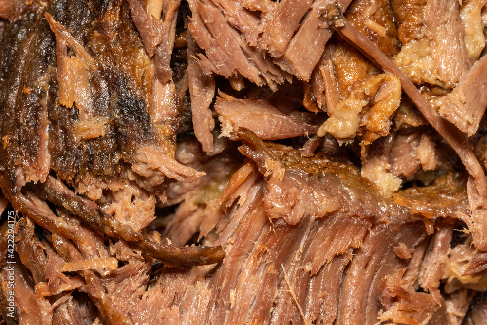 Slow cooked shredded pulled beef close up background viewed from above, stock photo image