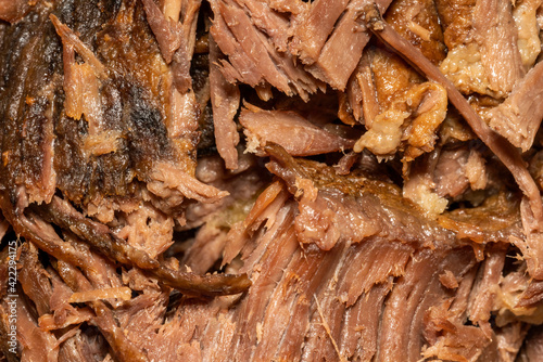Slow cooked shredded pulled beef close up background viewed from above, stock photo image