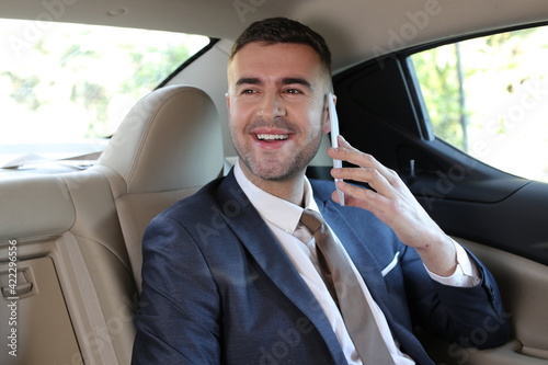 Businessman using phone in taxi  © ajr_images