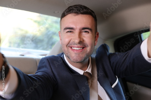 Businessman taking a selfie during road trip  © ajr_images