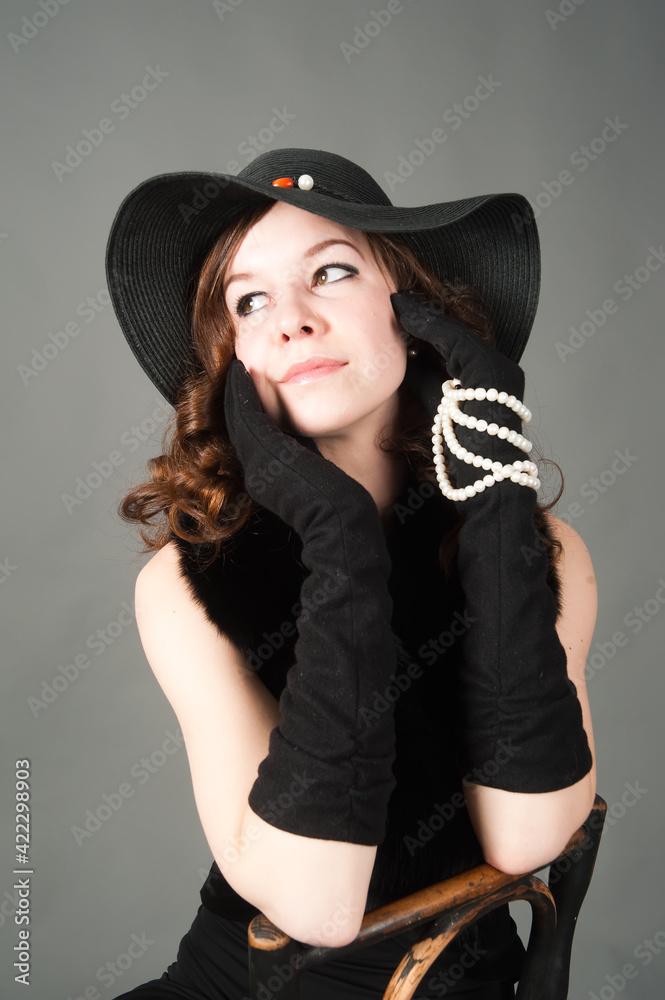 Pretty woman on chairin hat Pretty woman on chairin hat