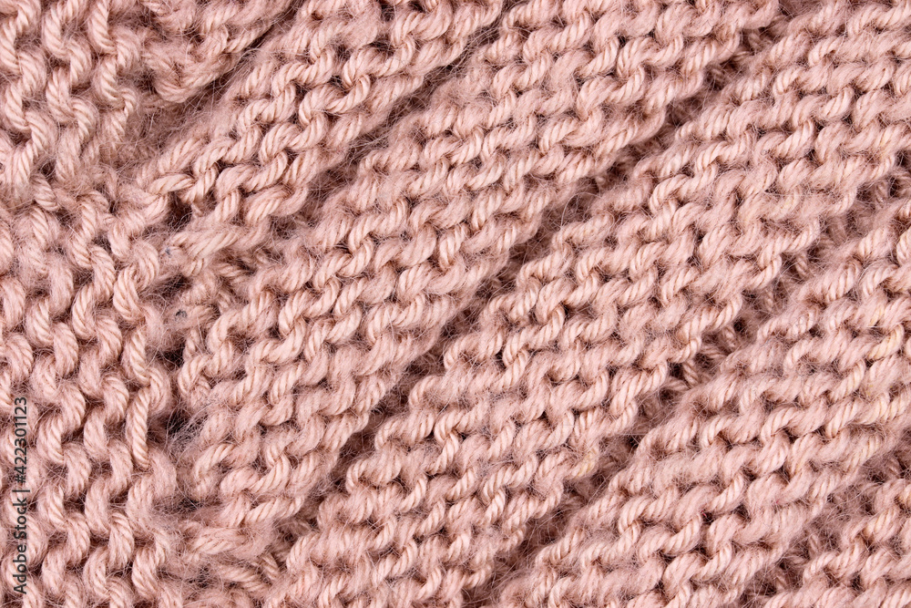 close-up of a pink knitted wool fabric background close-up of a pink knitted wool fabric background