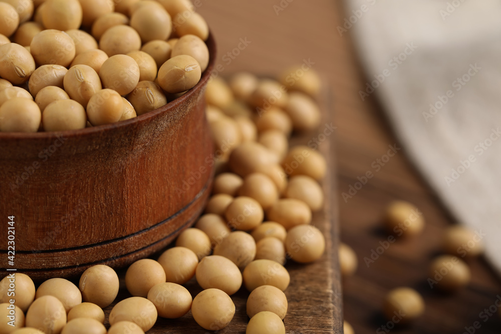 Natural soy beans on wooden table, closeup. Space for text Natural soy beans on wooden table, closeup. Space for text