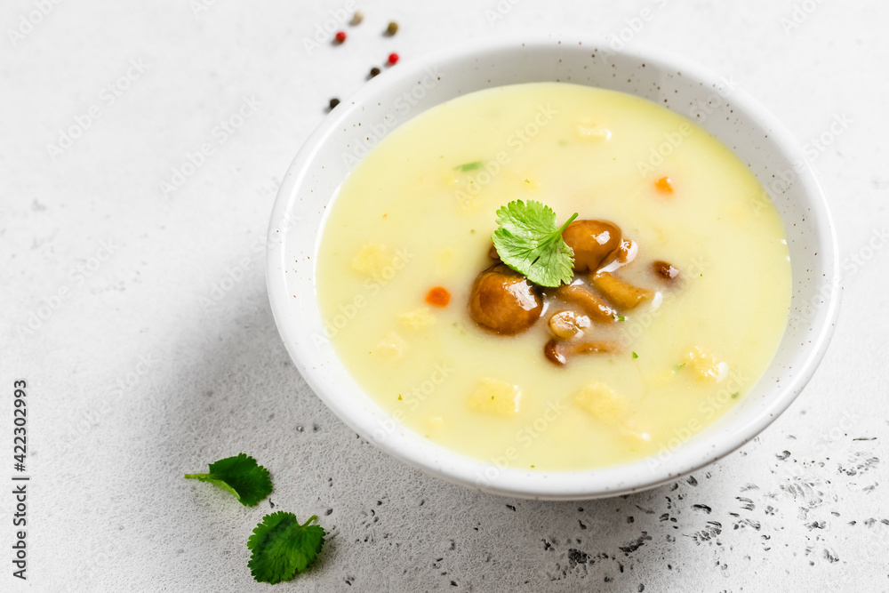Creamy homemade mushroom soup in a bowl. Space for text. Creamy homemade mushroom soup in a bowl. Space for text.