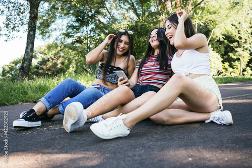 Teenage friends take a selfie. women friends on the asphalt