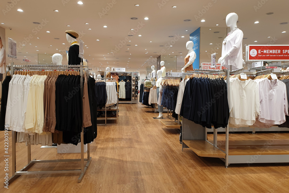 Interior view of Uniqlo store in a shopping mall, Penang. Uniqlo Co., Ltd.  is a Japanese casual wear designer, manufacturer and retailer. PENANG,  MALAYSIA - 18 MAR 2021. Stock Photo | Adobe Stock