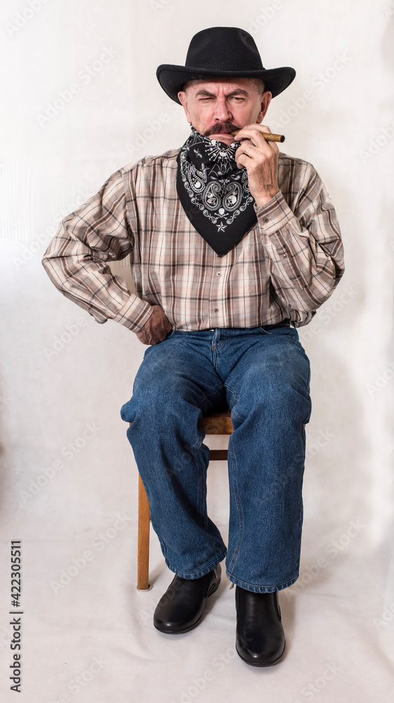 The cowboy with mustache, in a black hat smoking a cigar The cowboy with mustache, in a black hat smoking a cigar