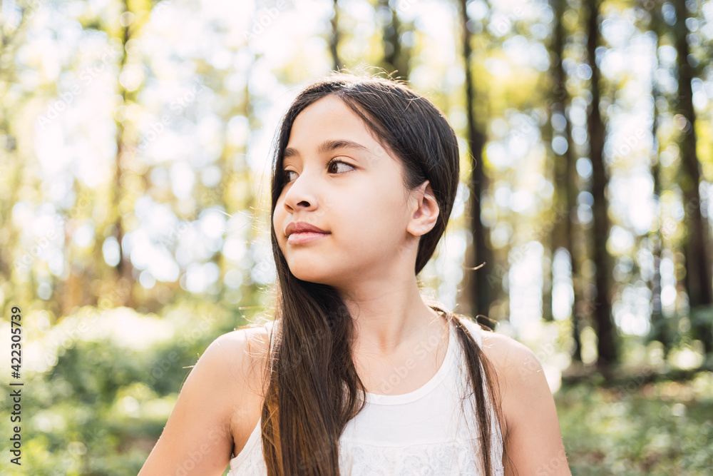 Profile of a beautiful little girl in a garden. Profile of a beautiful little girl in a garden.