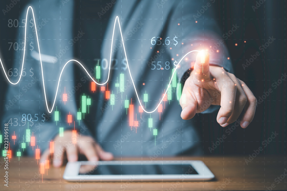 Businessman touching stock market technical chart on virtual screen of tablet for analysis financial information data , Value investor concept. Businessman touching stock market technical chart on virtual screen of tablet for analysis financial information data , Value investor concept.