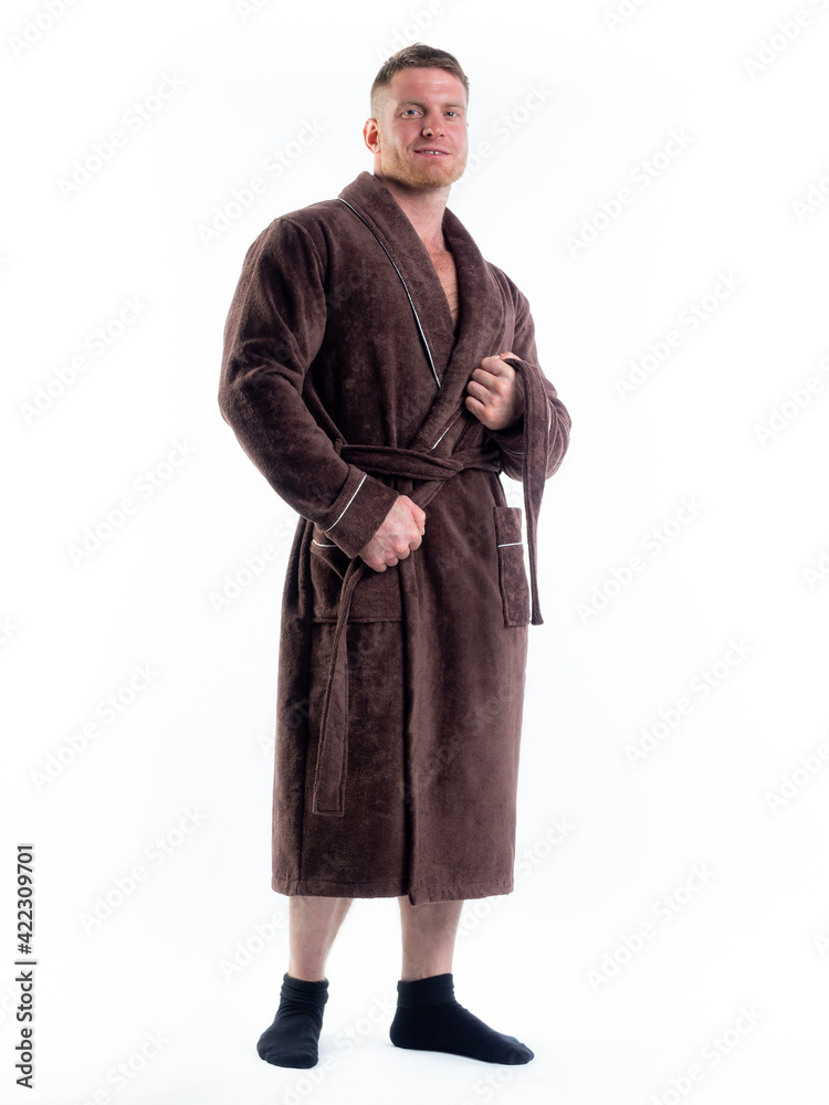 strong man in a Bathrobe on an isolated white background with a smile on his face. strong man in a Bathrobe on an isolated white background with a smile on his face.