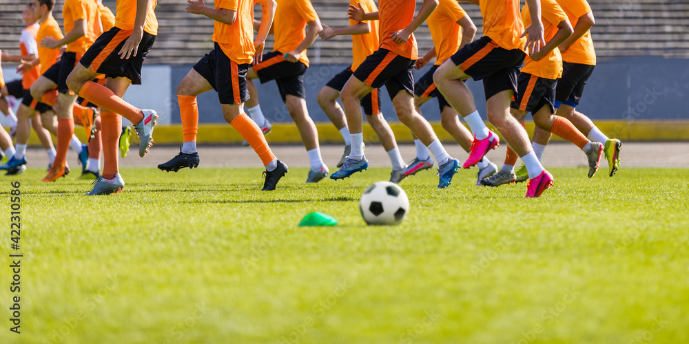Football Club Training Session. Soccer Players on Daily Practice Unit. Athletes Running on Soccer Grass Field. Soccer Team Training Together Before League Competition Match Football Club Training Session. Soccer Players on Daily Practice Unit. Athletes Running on Soccer Grass Field. Soccer Team Training Together Before League Competition Match