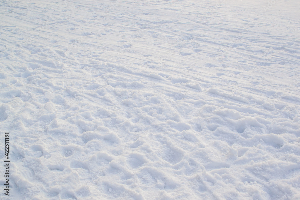 Trampled light white snow, footprints texture. Snowy winter park. Minimalism Trampled light white snow, footprints texture. Snowy winter park. Minimalism