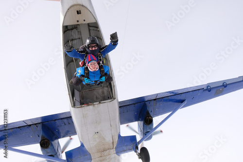 Fototapeta Naklejka Na Ścianę i Meble -  Skydiving. Tandem jump. Man and woman. Winter season.