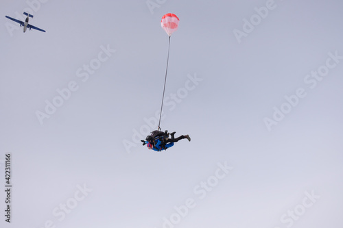 Skydiving. Tandem jump. Man and woman. Winter season.