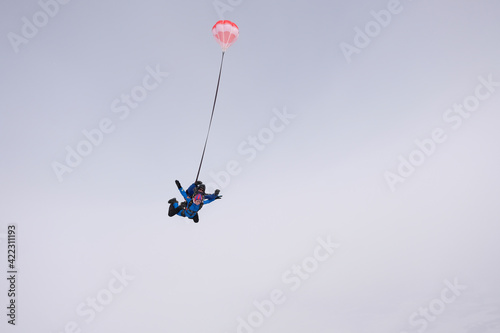 Skydiving. Tandem jump. Man and woman. Winter season.