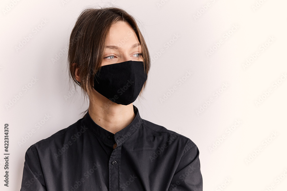 Obraz premium European girl in black shirt and mask