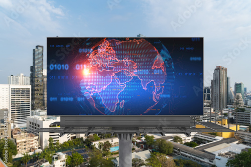 World planet Earth map hologram on billboard over panorama city view of Bangkok. The concept of international connections and business in Southeast Asia.