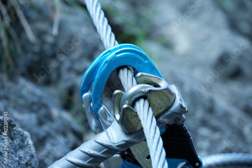 Two blue Carabiners hooked into a Steel Cable on the via Ferrata Citywall in Salzburg photo