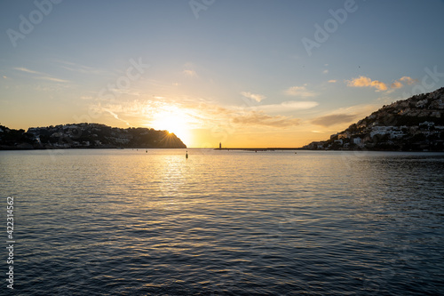 Beautiful sunset in Puerto de Andratx with a lighthouse in the background. Palma de Mallorca, Spain
