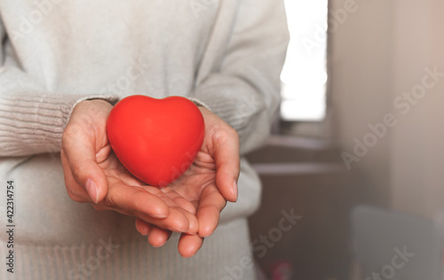 Fototapeta Naklejka Na Ścianę i Meble -  Red hearts with loving and caring adults. Symbol of support that expresses love valentine day and world heart day, heart health concept