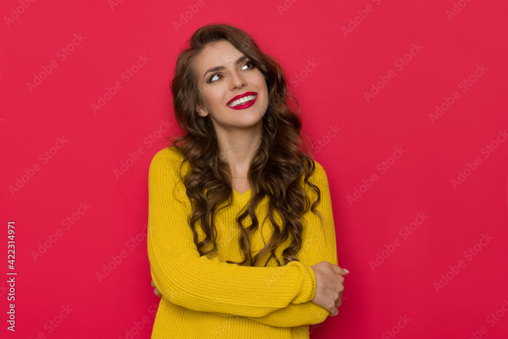 Happy Beautiful Young Woman Holding Arms Crossed And Looking Up